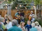 A bluegrass band performing in an outdoor space.