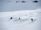 Three skiers headed down a powdery mountain in Iceland.