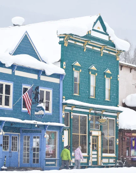 Storefronts in a snowy downtown in Crested Butte.