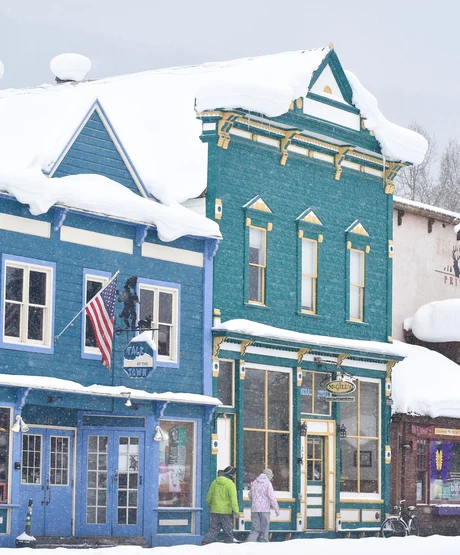 Storefronts in a snowy downtown in Crested Butte.