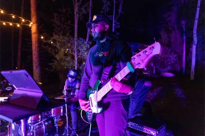 A band outside at night in Colorado at an outdoor dinner party.