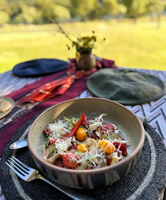 A fresh meal plated on a table outdoors.