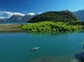 People fly fishing on a small boat on a river in Patagonia.