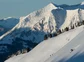 A person skiing down a steep slope terrain in the Rockies.