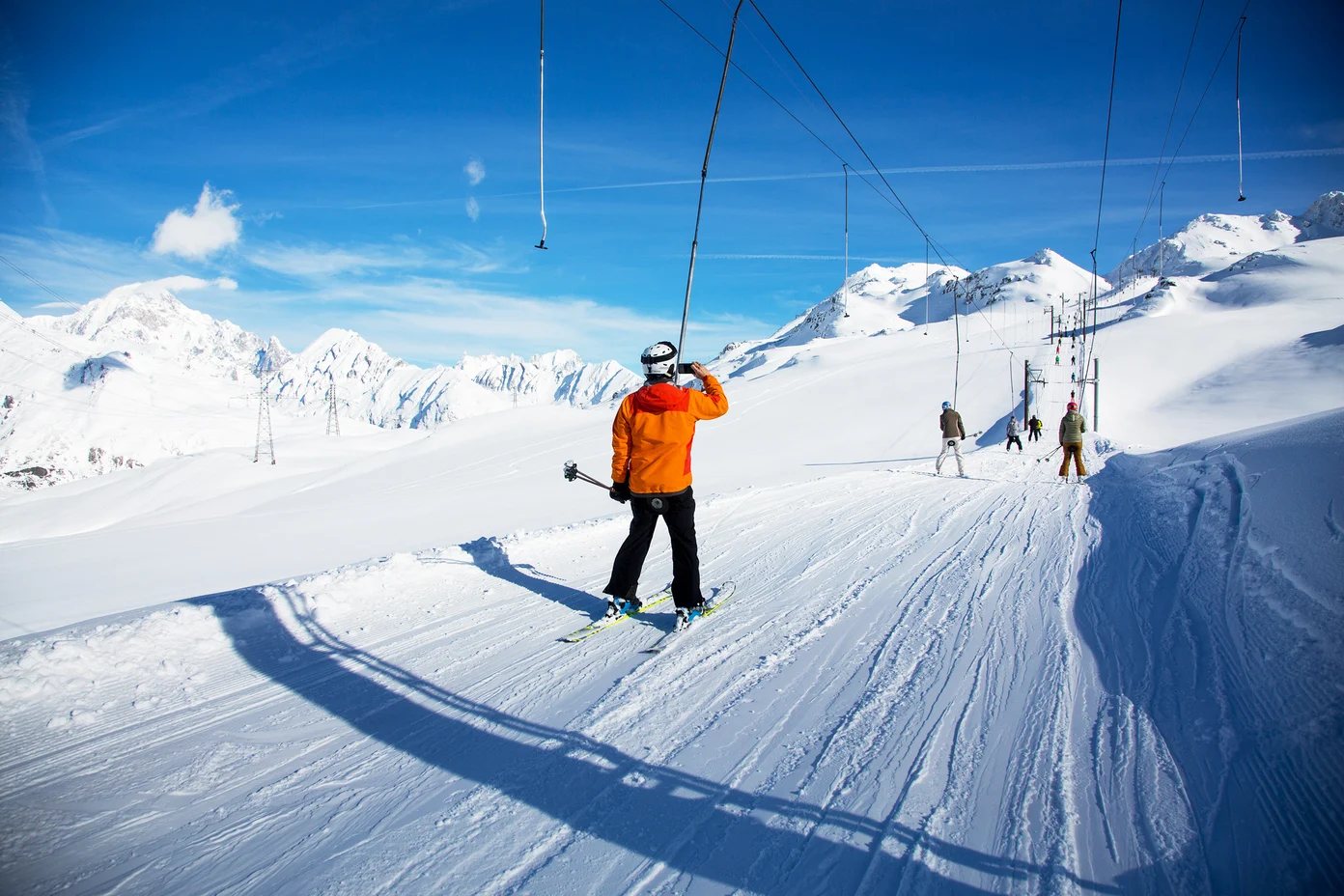 Skiiers on poma lift in France.