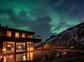 People enjoying the heated outdoor pool with the Northern Lights overhead.