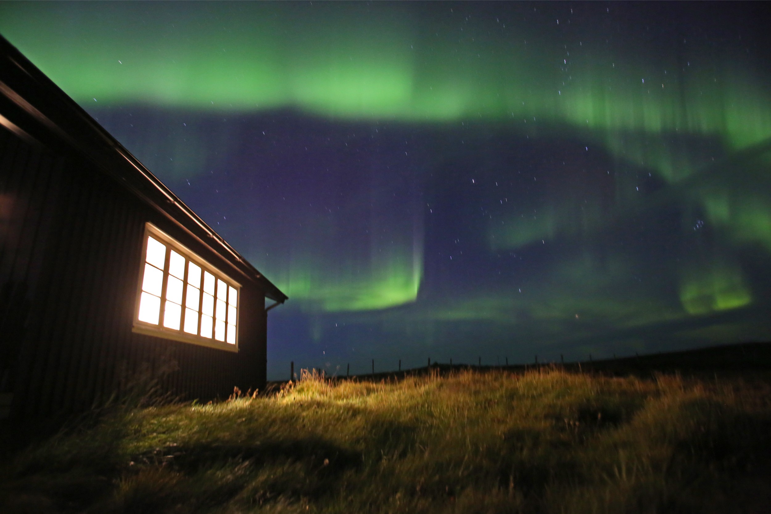 The Northern Lights over the Holkna Studio in Iceland.