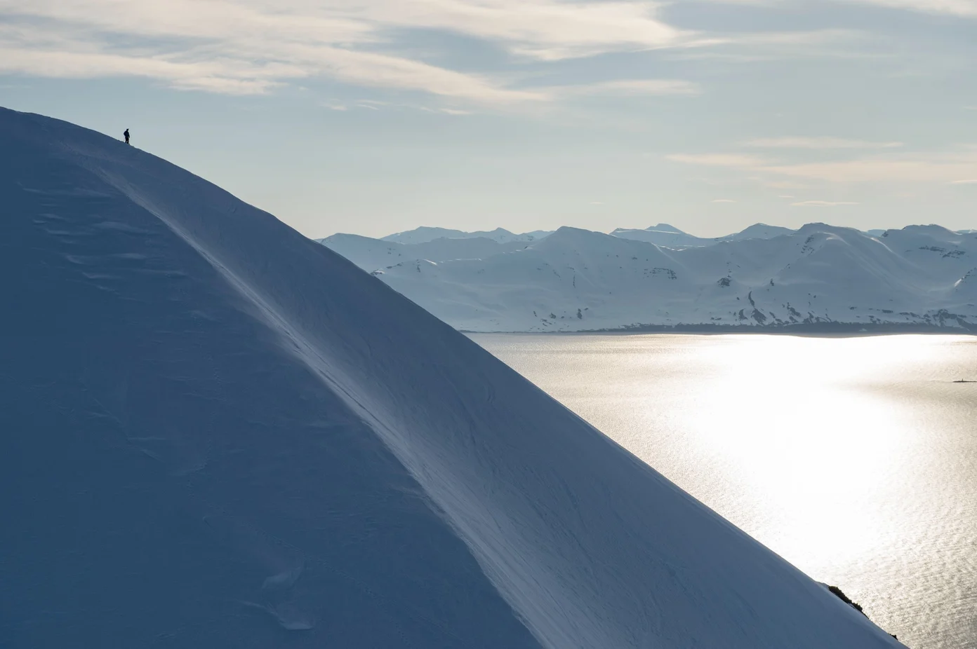 The view of a mountain ridge at sunset in the winter.