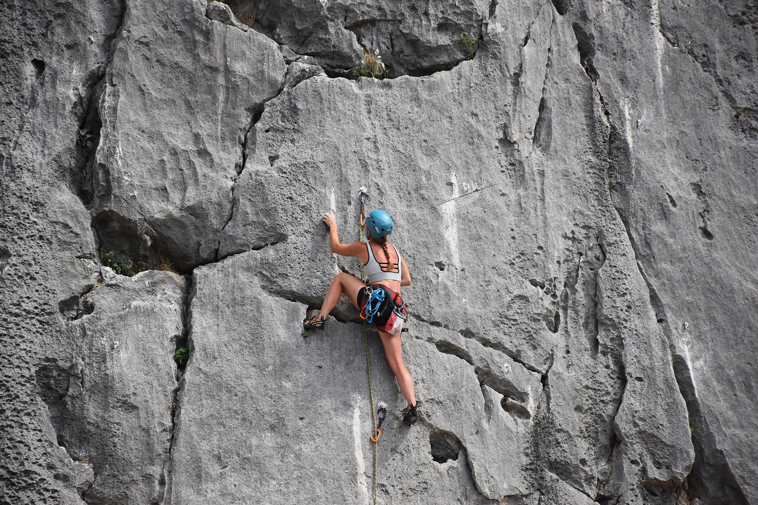 Woman rock climbing in the mountains.