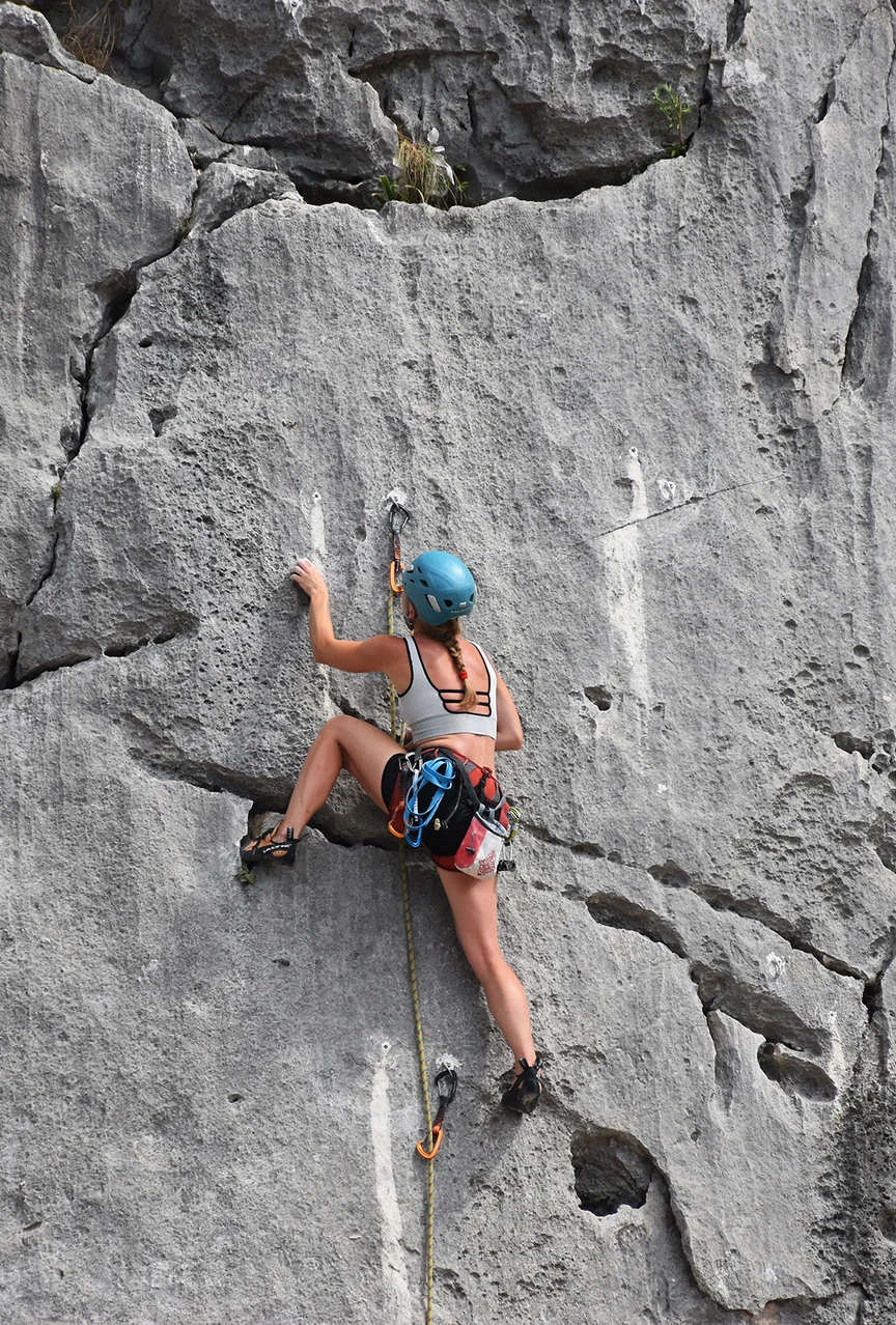 Woman rock climbing in the mountains.