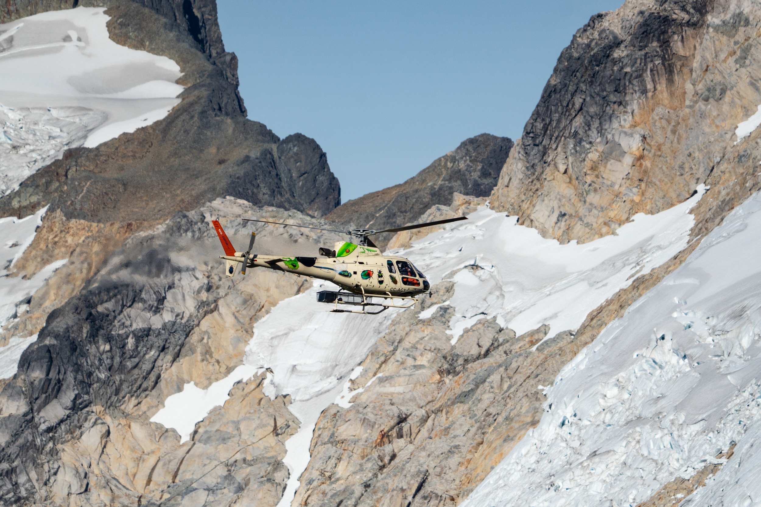 Helicopter flying through Patagonian mountains.