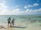 A guide points out a fish to an angler in the Bahamas.