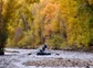 An angler casts from a boat on the Gunnison River.